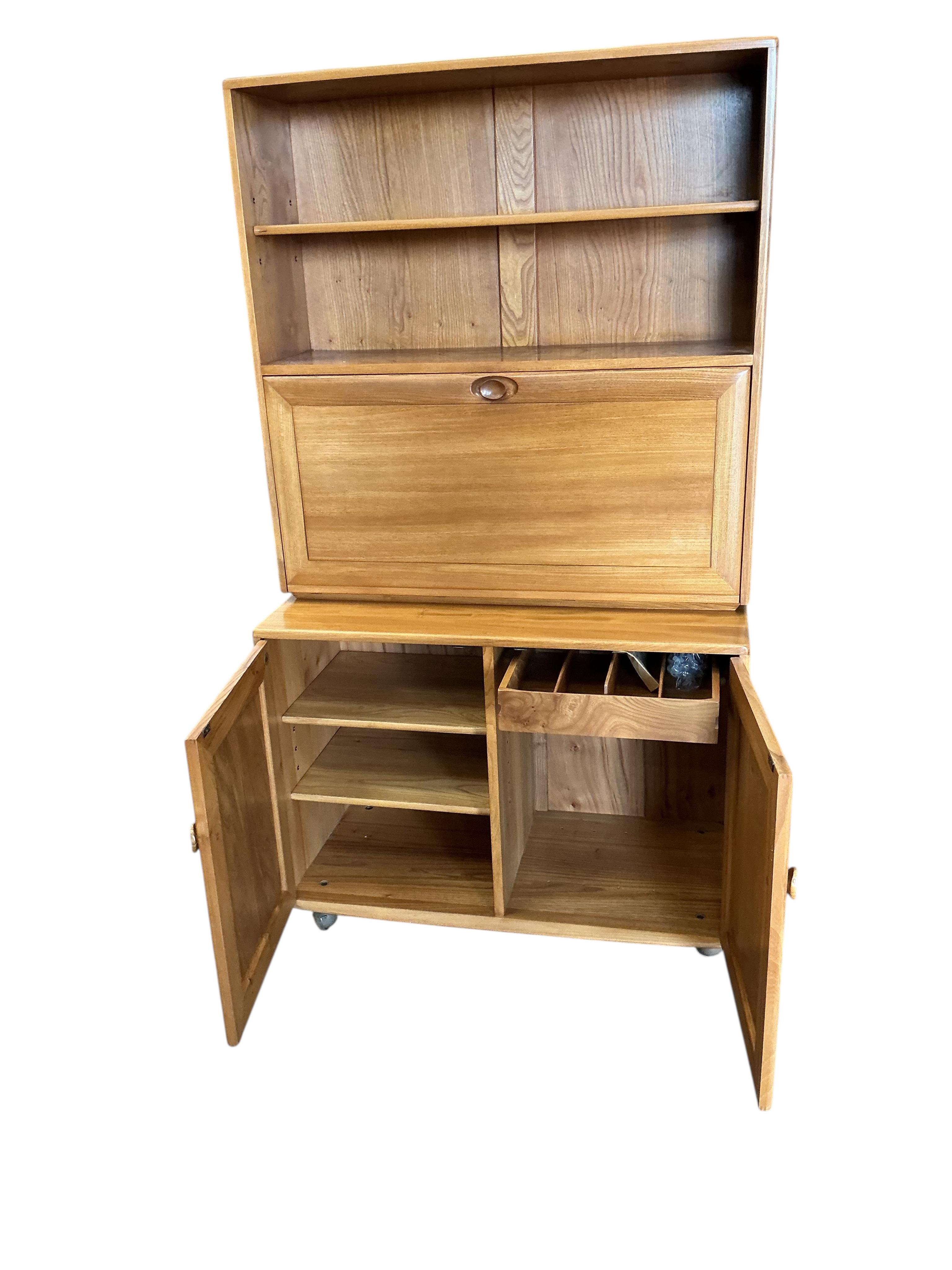 An Ercol Windsor light elm writing cabinet, width 91cm, depth 45cm, height 163cm
